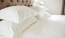 photo of a bed with white linens and pillows