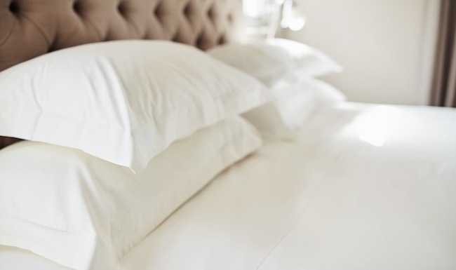 photo of a bed with white linens and pillows