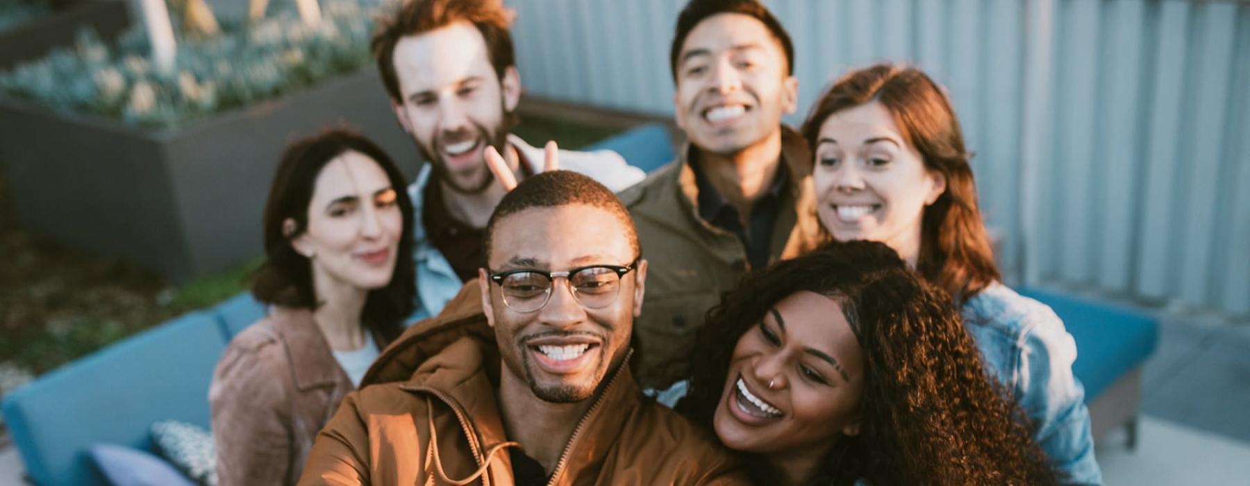 Group of friends taking a selfie outdoors together