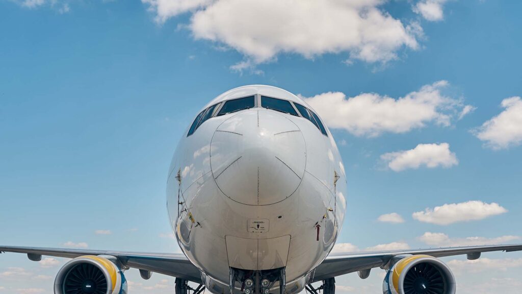 Airplane sitting on a runway over a blue sky