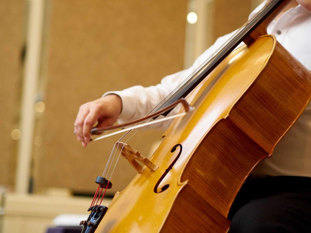 Musician playing the cello in a concert hall