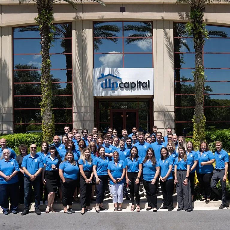 Group of DLP Capital team members outside their corporate office